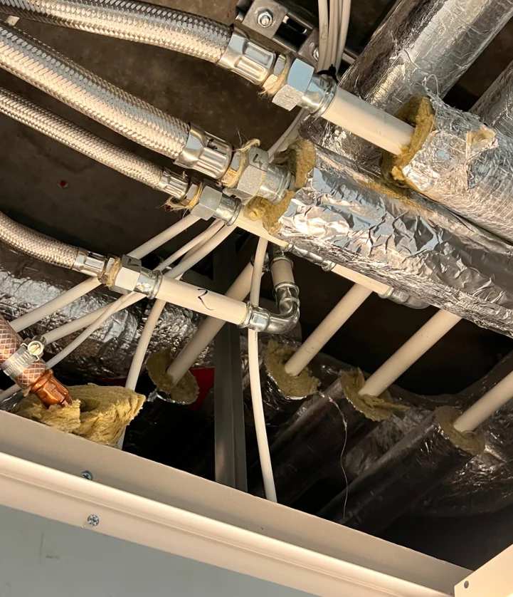 Existing heating pipework and connections recorded during an office condition survey